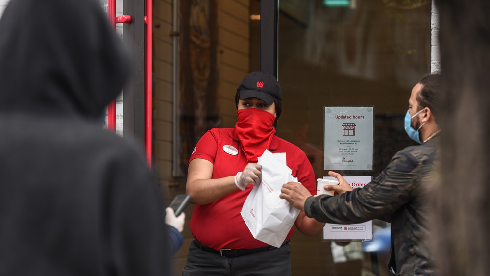 A Chick-fil-A employee wearing a mask. 