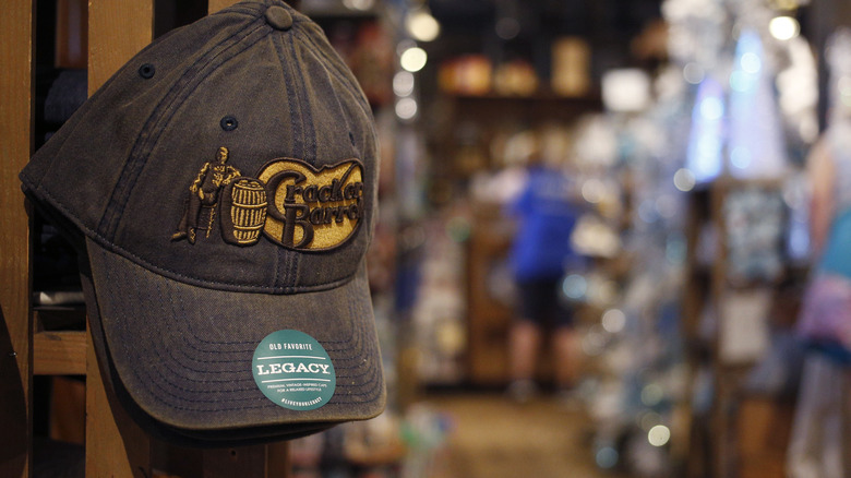 Hat with Cracker Barrel logo hanging on a peg