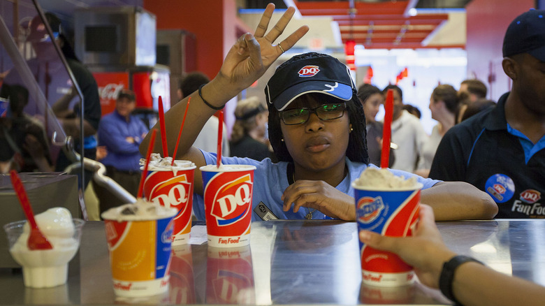 Dairy Queen worker serving ice cream to customers