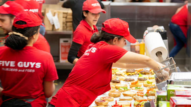 Five Guys workers cooking food