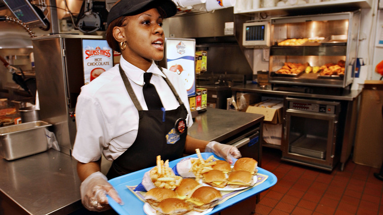 White Castle employee holding tray