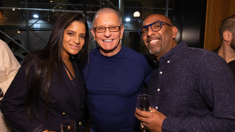 Robert Irvine posing with a man and a woman