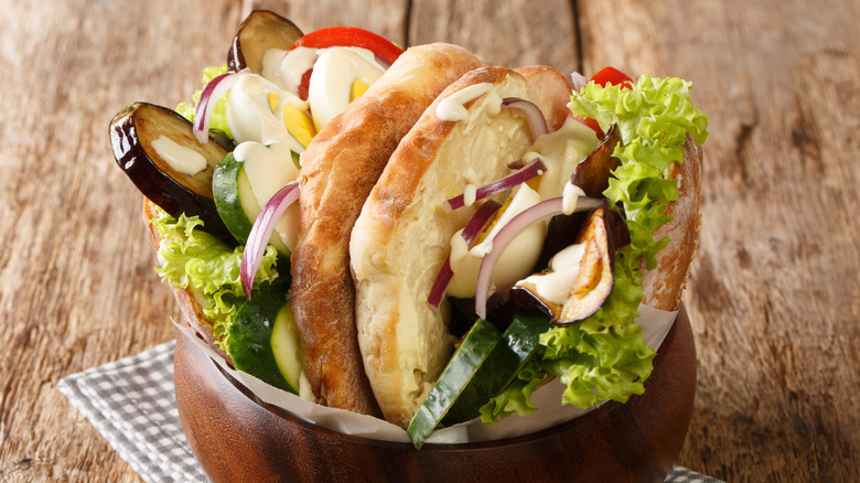 Sabich with eggs and veggies in a bowl