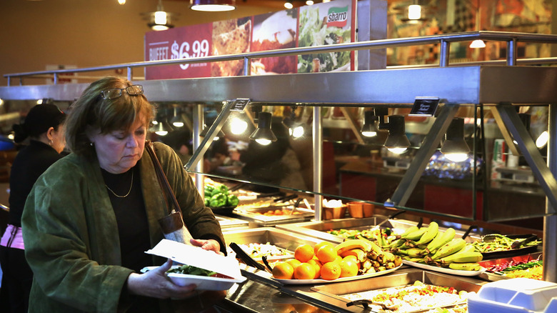 A woman picking up food at a Sbarro in Reagan Station