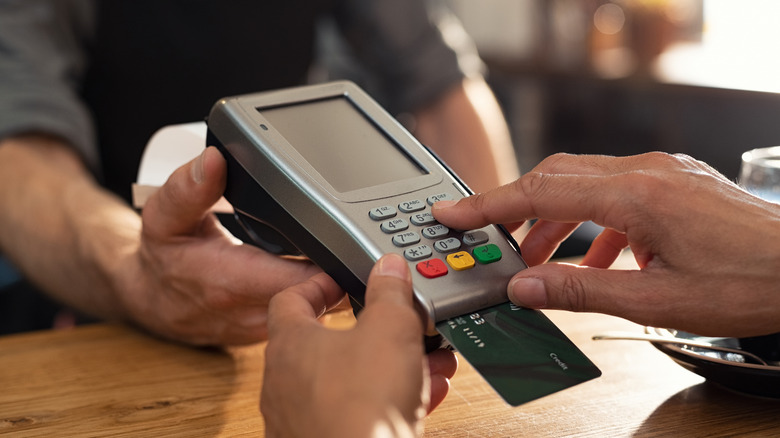 Woman paying with credit card