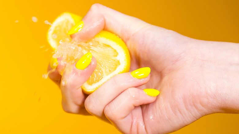 Hand squeezing lemon 