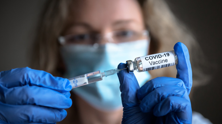 medical worker holding covid-19 vaccine