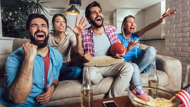 Friends cheering on their Super Bowl team