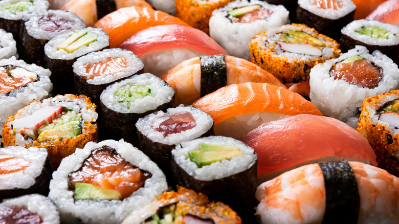 platter of sushi with different rolls and sashimi