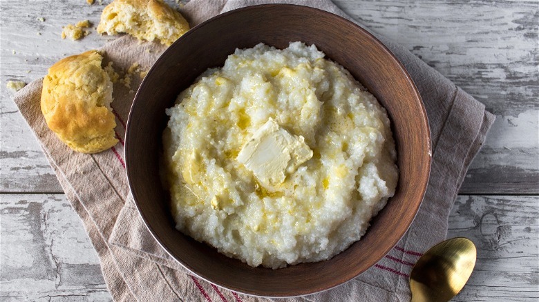 Grits with butter in wooden bowl 