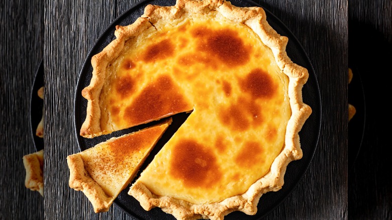 A baked and browned sugar cream pie with a slice cut out