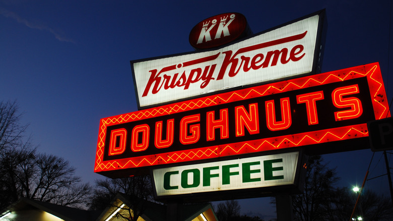 a krispy kreme sign at night 