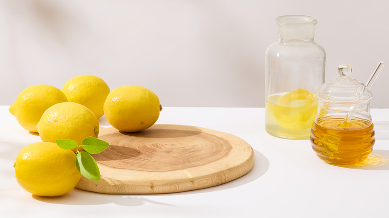 Honey and lemon on table