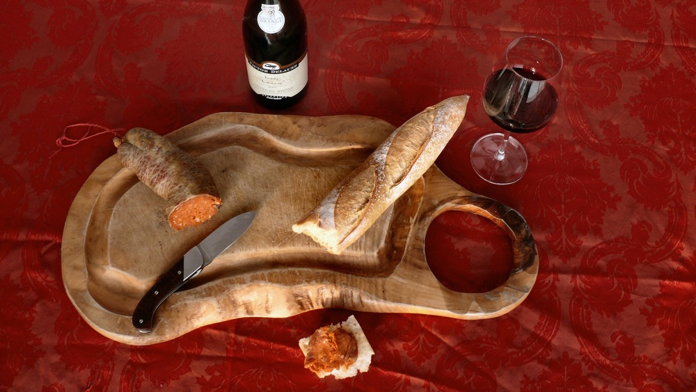 Charcuterie board with bread, meat, and wine