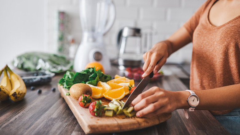 Person chopping fruit