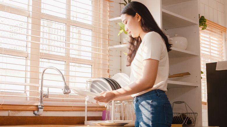 woman hand-washing dishes