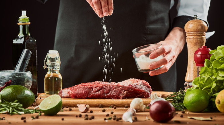 seasoning steak with salt