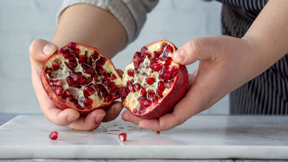 a pomegranate being torn open