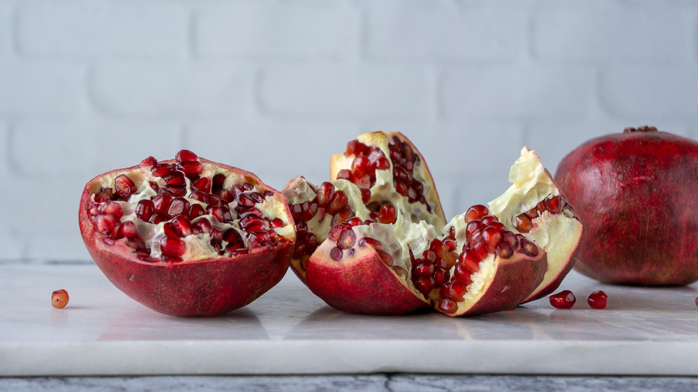 pomegranate cut into halves and wedges