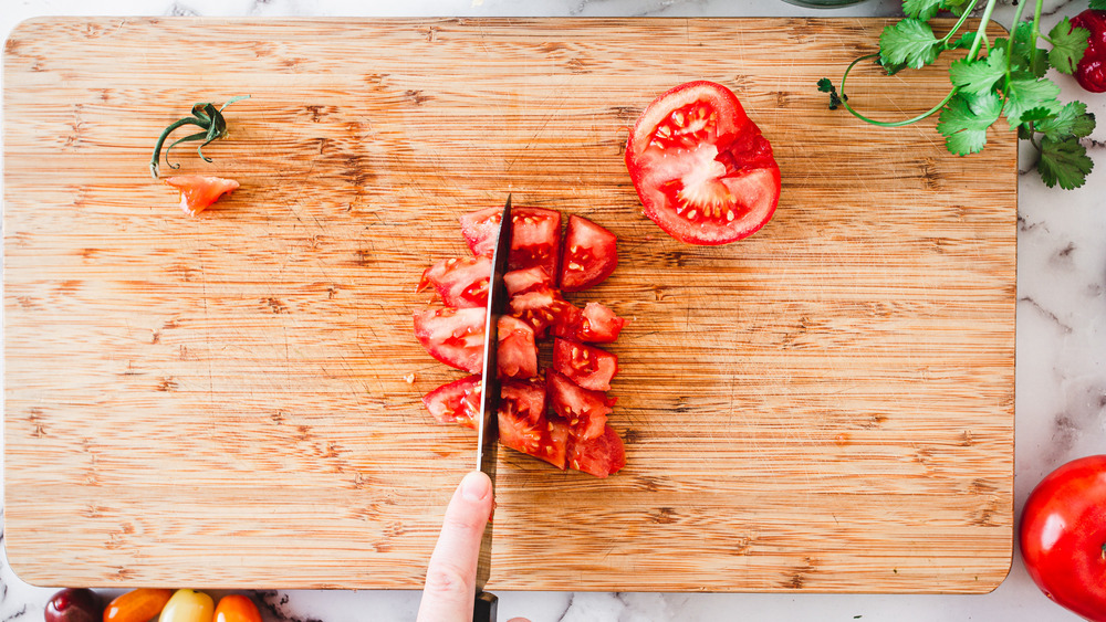 cutting a tomato face up