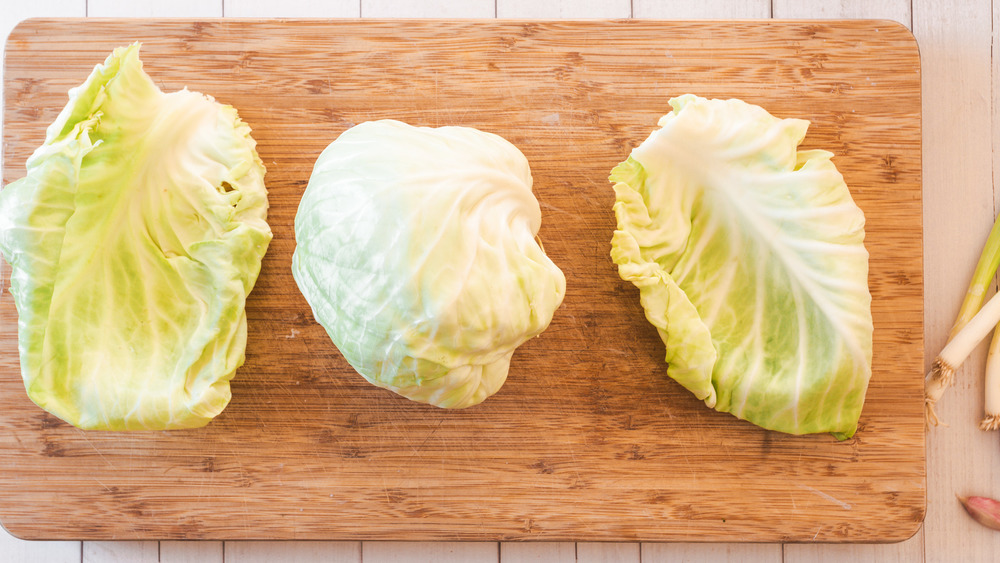 peeling off leaves from cabbage