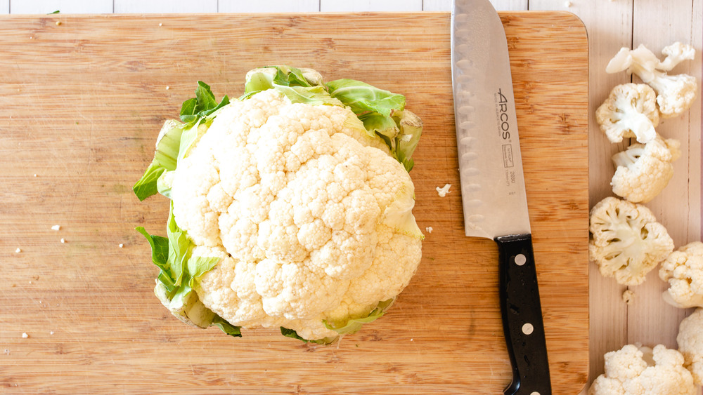 cauliflower on cutting board with knife