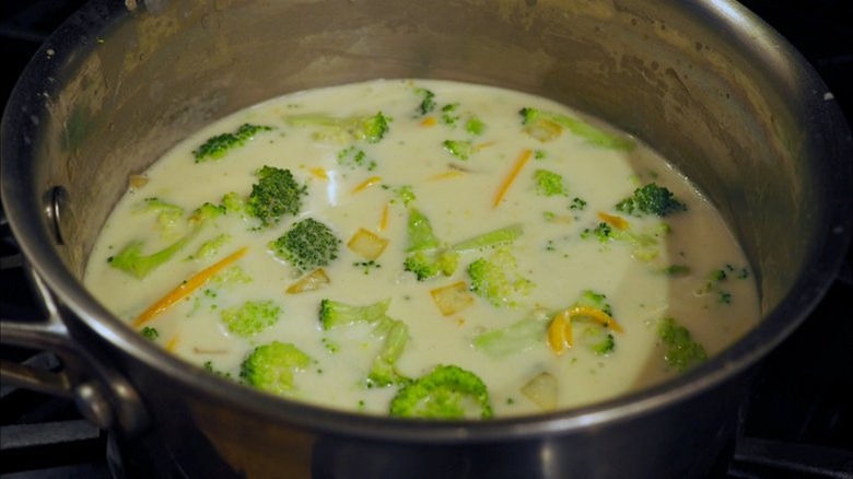 stovetop pot of broccoli cheddar soup 