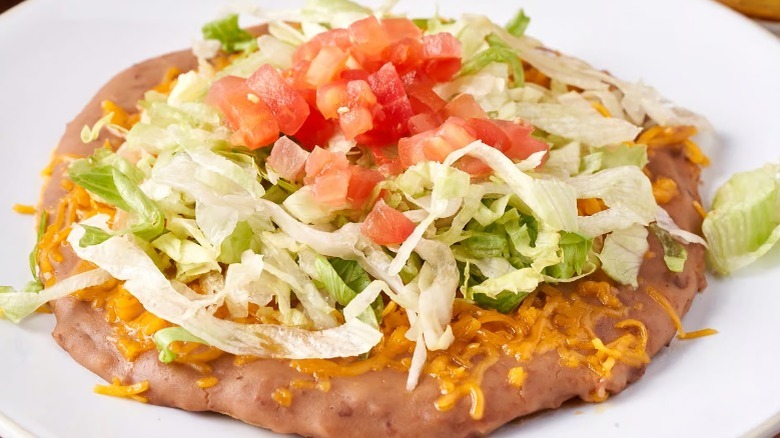 bean tostada on white plate