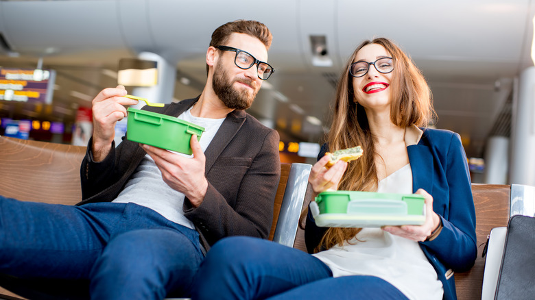 Couple eating at airport