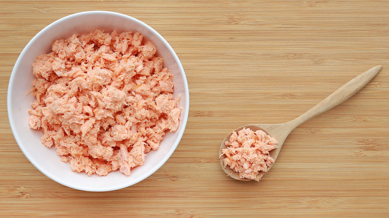 shredded salmon in a white bowl