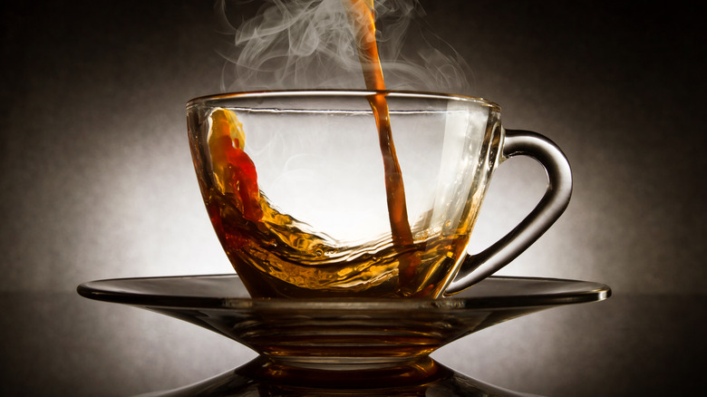 Coffee pouring into glass cup