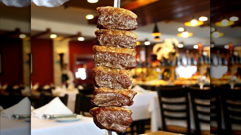 close up of chunks of meat on a skewer