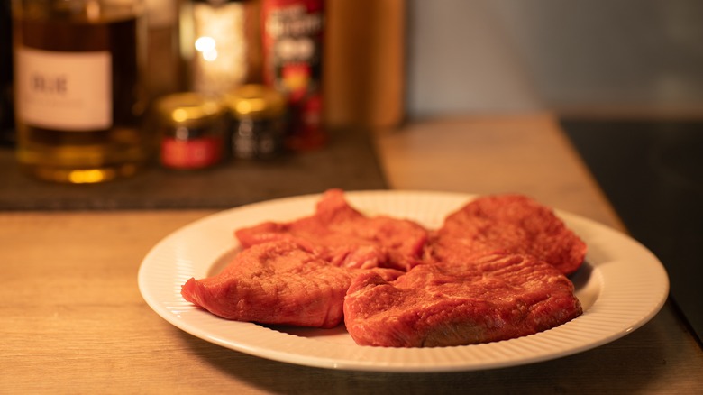 Raw steaks on a plate