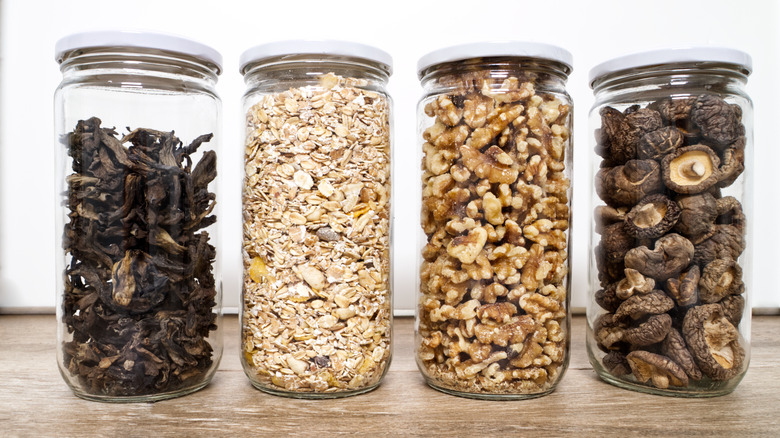 Dry nuts and mushrooms in jars