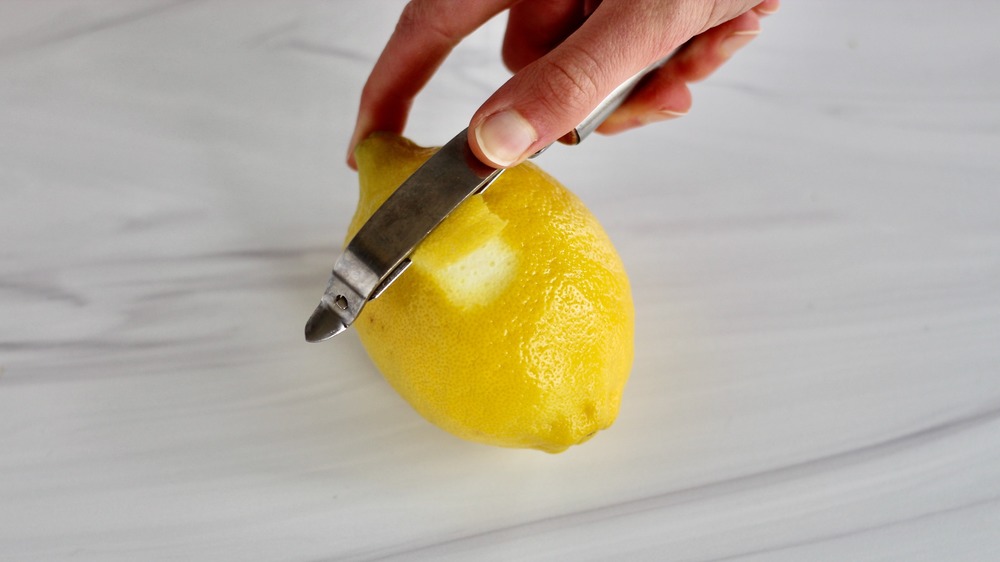 Peeling lemon zest with a vegetable peeler