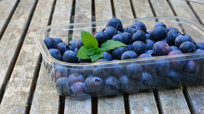 A box of blueberries on a wooden table