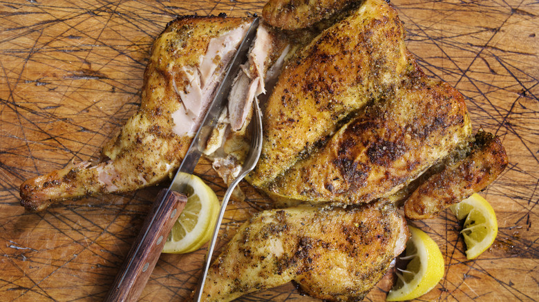 Sliced chicken on wooden board