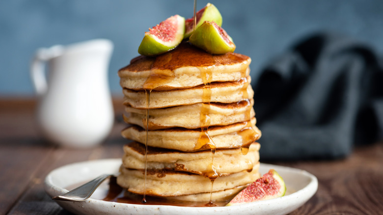 fluffy stack of pancakes with syrup