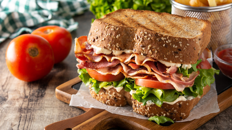 Toasted BLT sandwich on wooden board