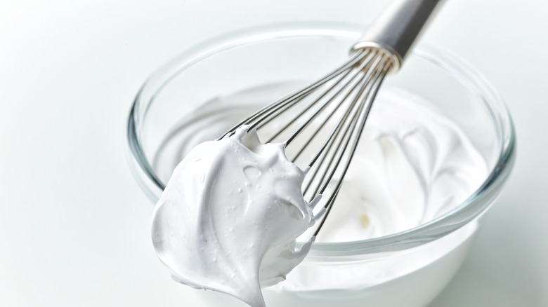 Whipped egg whites on whisk