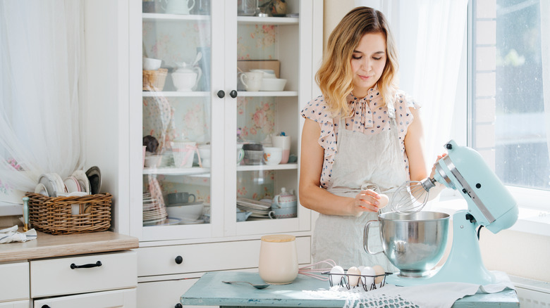 Woman preparing dough in a standing mixer