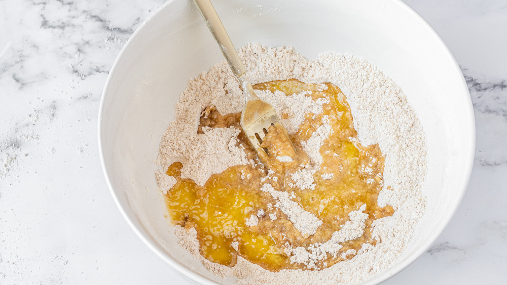 adding melted butter into a bowl