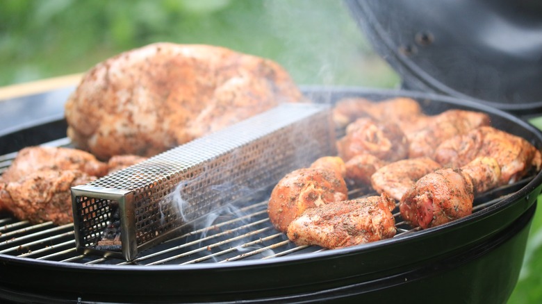 Meat on grill with smoker tube