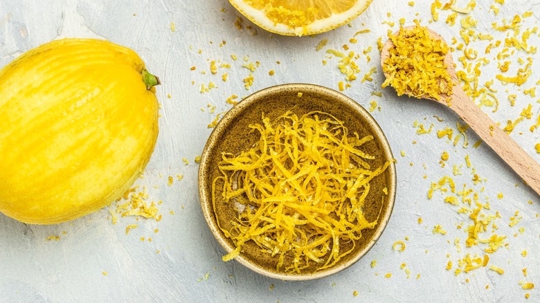 Bowl of lemon zest next to zested lemon