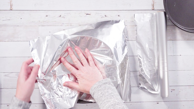 Person putting foil into springform pan