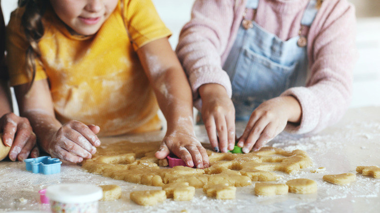 People Using Cookie Cutters in dough