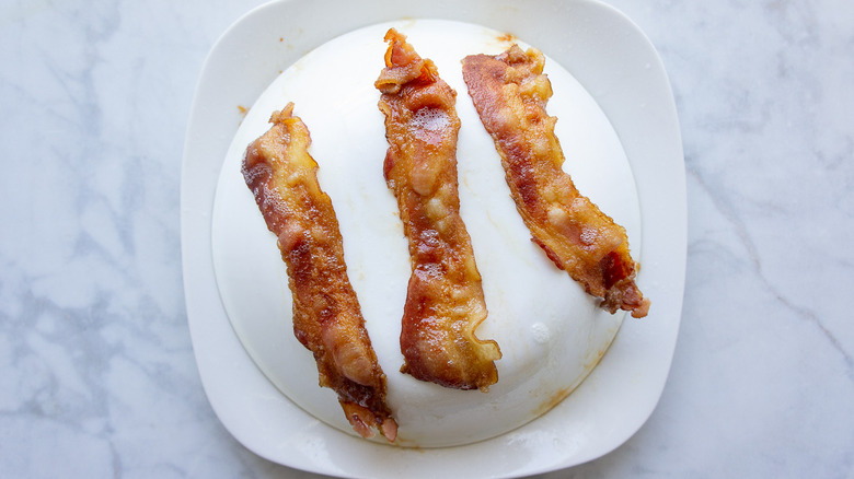 cooked bacon on top of a bowl