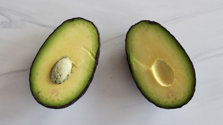 Two avocado halves