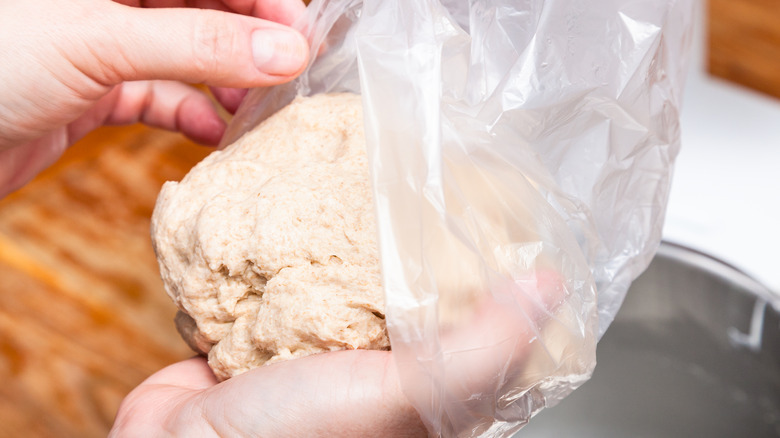 Dough being placed into a plastic bag