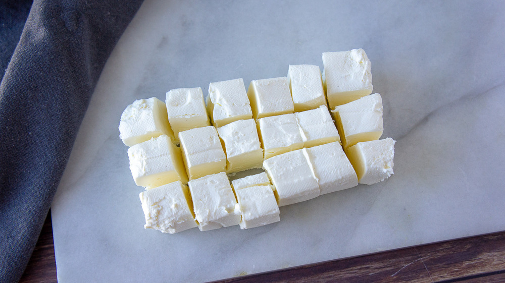 a block of cream cheese sliced into small squares